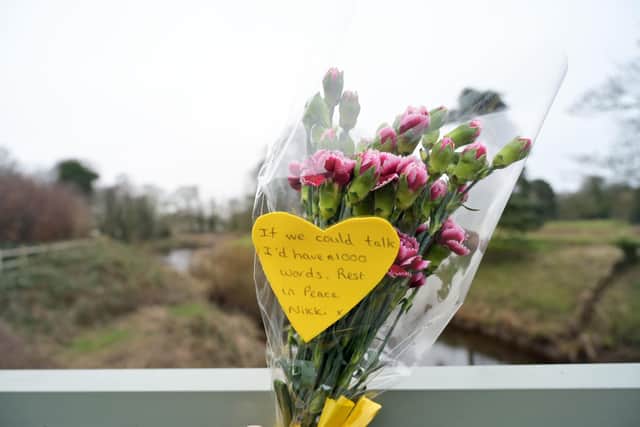 Flowers and a message tied to a bridge over the River Wyre (Credit: Dave Nelson/ PA)