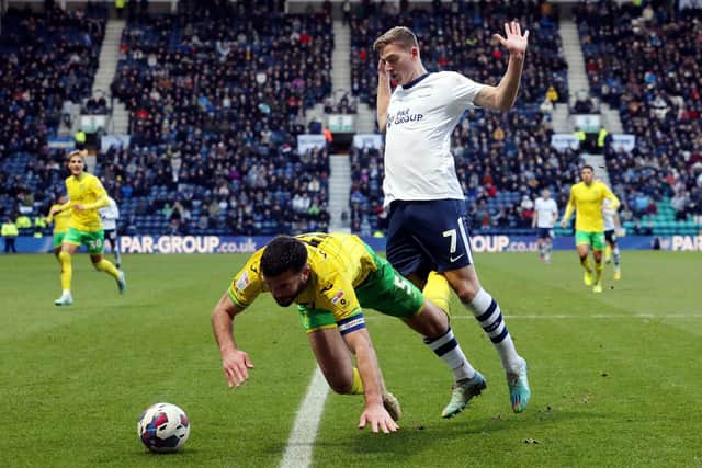 Norwich’s Grant Hanley goes down under the challenge from Liam Delap