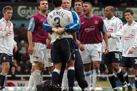 Brian O'Neil is held back by PNE physio Andrew Balderston in the game at West Ham