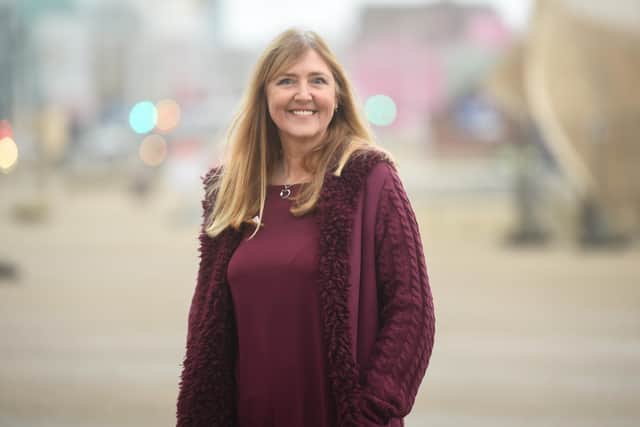 Lisa McNeill outside Blackpool Tower, which is lit purple for World Aspergillosis Day on Feb 01.