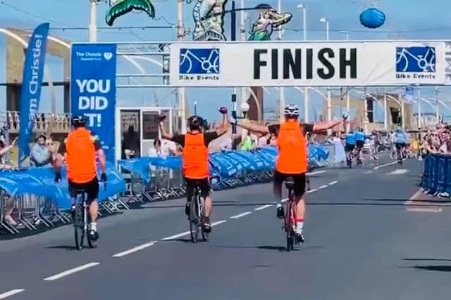 The cyclists reach the finish line after riding 60 miles in from Manchester to Blackpool