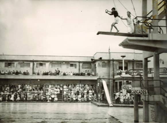 Before the Miss Great Britain competition rounds, male acrobats the ‘Aqua-Loonies’ presented a diving act from various platforms. Here they are pictured pushing Morecambe 12-year-old schoolboy Charlie Overett from the board in 1957.