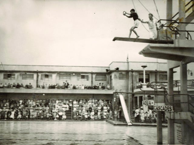 Before the Miss Great Britain competition rounds, male acrobats the ‘Aqua-Loonies’ presented a diving act from various platforms. Here they are pictured pushing Morecambe 12-year-old schoolboy Charlie Overett from the board in 1957.