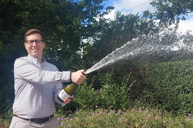 Estate agent Michael Bailey celebrates his company's ranking kin the top five per cent in the UK