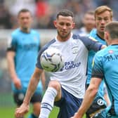 Preston North End skipper Alan Browne battles with Millwall's Murray Wallace at Deepdale