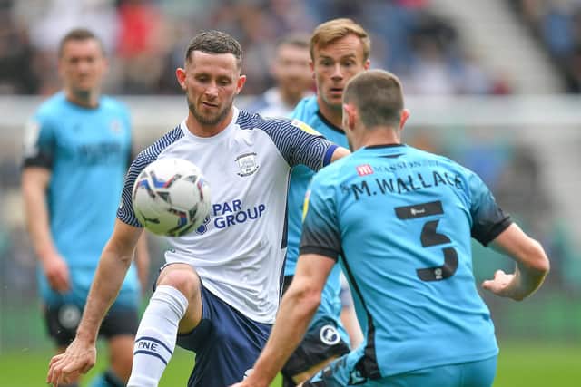 Preston North End skipper Alan Browne battles with Millwall's Murray Wallace at Deepdale