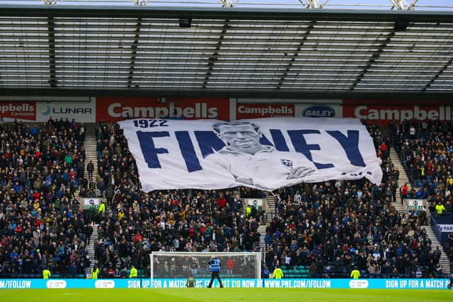 The Sir Tom Finney surfer flag is paraded by Preston North End fans on the Alan Kelly Town End