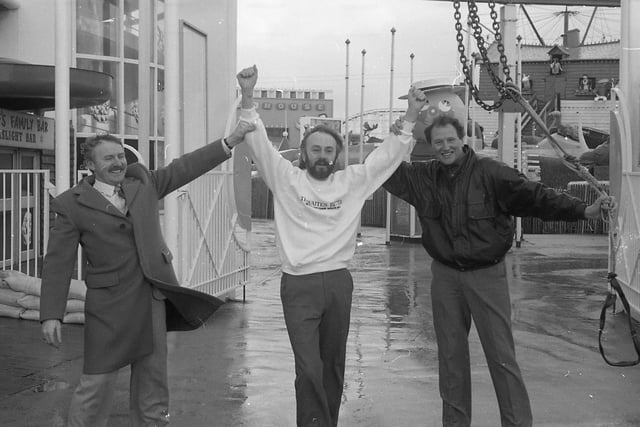 Escapologist John Roberto braved his winds at Blackpool to herald a top magic convention - hanging in a straitjacket 75ft above the ground on a burning rope. John - who escaped in the nick of time - was one of several artists who gave an impromptu free show on Blackpool Promenade. John is pictured above with Derek Lever, president of Blackpool Magicians Club, and convention organiser Tom Owen