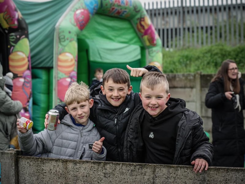 Three young fans pose for a photo