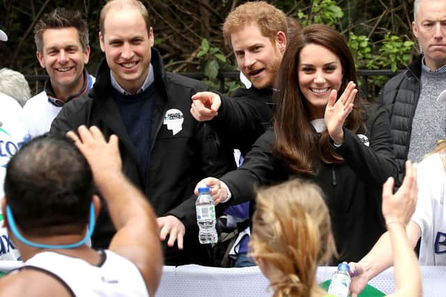 The then Duke and Duchess of Cambridge and the Duke of Sussex (centre) handing out water to runners during the 2017 Virgin Money London Marathon