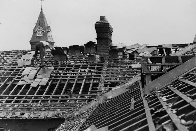 A workman removes slates from the roof in the first stage of demolition of St Vincent's School, Fulwood, back in 1960