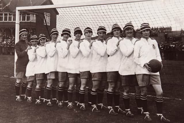 The Dick, Kerr Ladies football team line up with Lilly Parr, goal scorer extraordinaire holding the football at the front