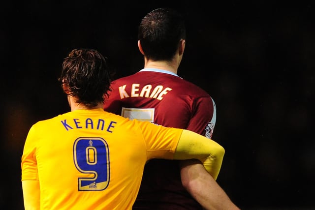 Preston North End's Will Keane, left, holds onto Burnley's Michael Keane