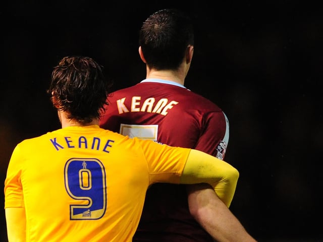 Preston North End's Will Keane, left, holds onto Burnley's Michael Keane