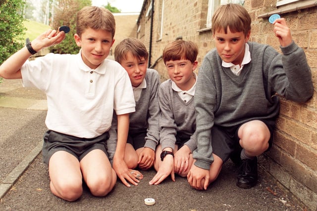 If you were a young kid in the 1990s chances are you will have played a game or two of this in the playground - it's Pogs. Pictured here is a game underway at Broughton Primary School
