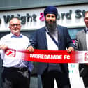 Panjab Warriors' Gurpreet Singh (centre) with Morecambe co-chairmen Rod Taylor (left) and Graham Howse (right) Photo: Morecambe FC
