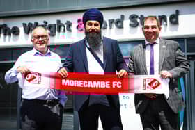 Panjab Warriors' Gurpreet Singh (centre) with Morecambe co-chairmen Rod Taylor (left) and Graham Howse (right) Photo: Morecambe FC