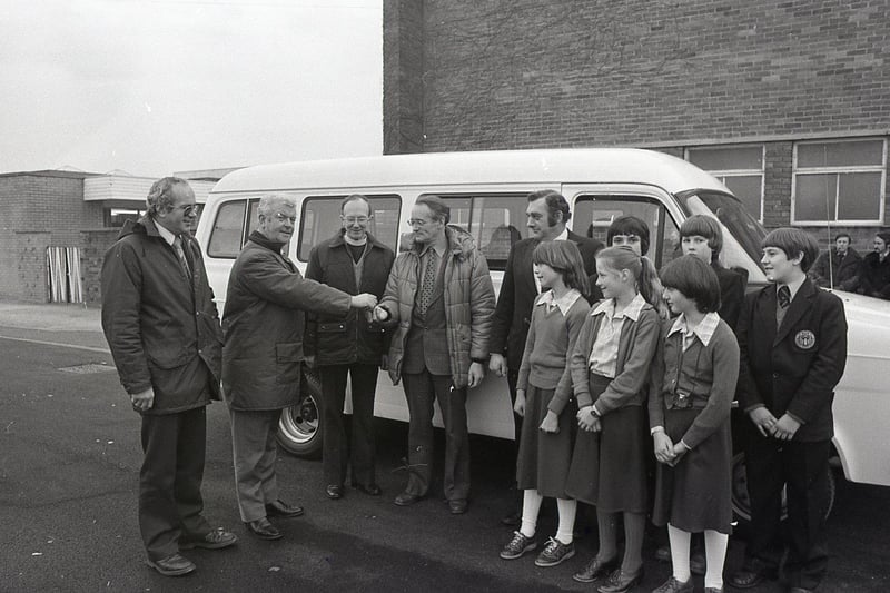 Mr Peter Healey of Bradshaws Motor House, hands over the keys of a new school minibus to headmaster Mr Pearce, watched by Mr David Saul, PTA chairman (left), Canon David Rees, Mr Mike Slater, PTA secretary and some of the pupils at Priory High School in Penwortham