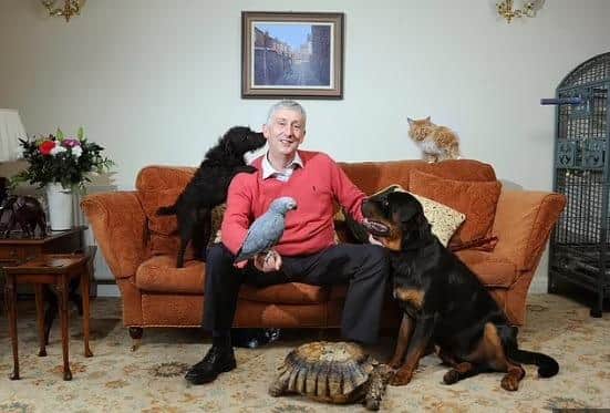 Sir Lindsay and his menagerie of pets, including Boris the parrot and Maggie the tortoise.
