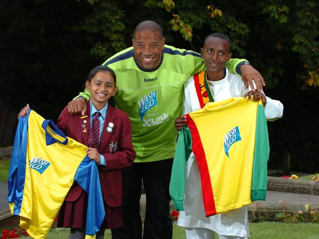 Football legend John Barnes hands over kit to Highfield Priory School pupil Shreya Chauhan and Binium Adisu of Score Ethiopia (Photo Neil Cross)