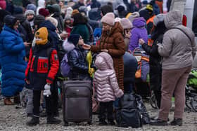 KROSCIENKO, POLAND - MARCH 07: People who fled the war in Ukraine wait to board a bus after crossing the Polish Ukrainian border on March 07, 2022 in Kroscienko, Poland. The country was already home to a large Ukrainian population of around 1.5 million, the region's largest, making Poland a major destination for refugees from the current war. (Photo by Omar Marques/Getty Images)