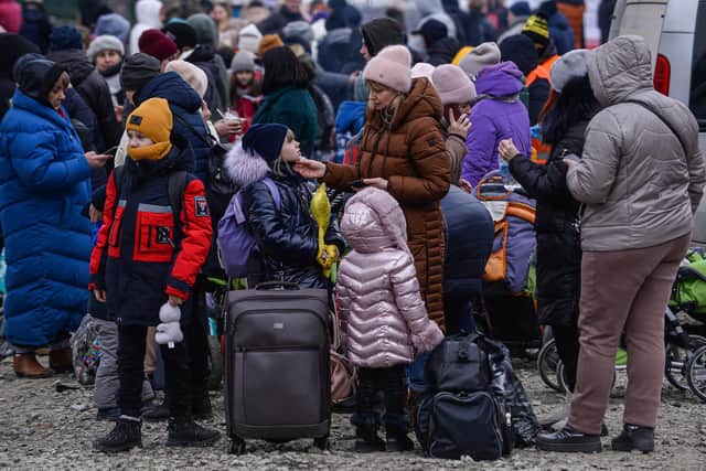 KROSCIENKO, POLAND - MARCH 07: People who fled the war in Ukraine wait to board a bus after crossing the Polish Ukrainian border on March 07, 2022 in Kroscienko, Poland. The country was already home to a large Ukrainian population of around 1.5 million, the region's largest, making Poland a major destination for refugees from the current war. (Photo by Omar Marques/Getty Images)