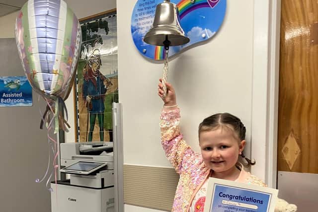 Camille rings the end of treatment bell