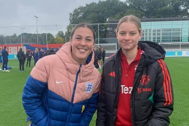 Aspiring goalkeeper Evie Mitchell with current England and Manchester United No.1 Mary Earps