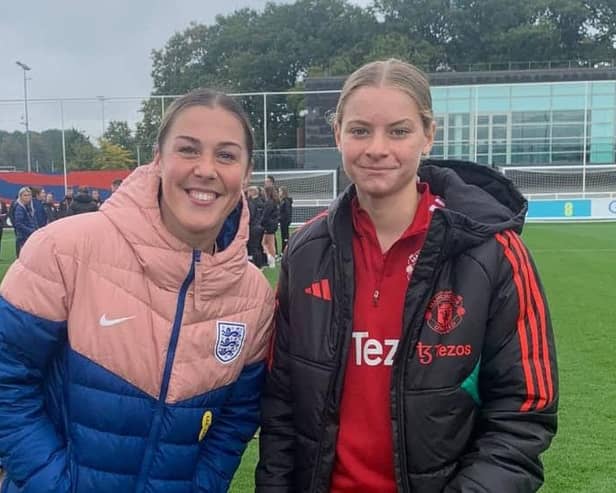 Aspiring goalkeeper Evie Mitchell with current England and Manchester United No.1 Mary Earps