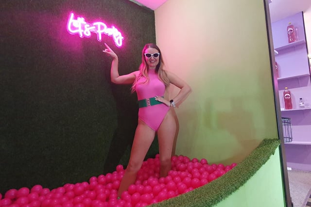 Come on Barbie, let's go party...Barbie poses in the pink ball pool