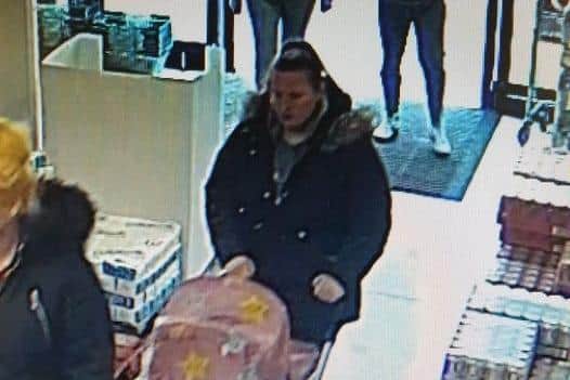 Police want to speak to this woman following a theft at a Farmfoods store in Accrington (Credit: Lancashire Police)