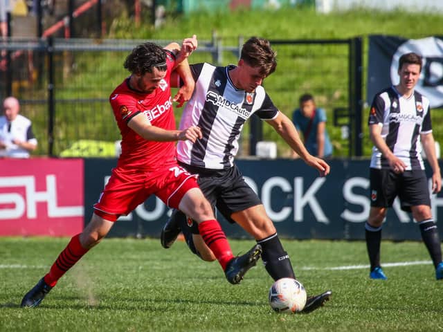 Chorley's Mike Calveley challenges for the ball against Darlington on Saturday (photo: Stefan Willoughby)