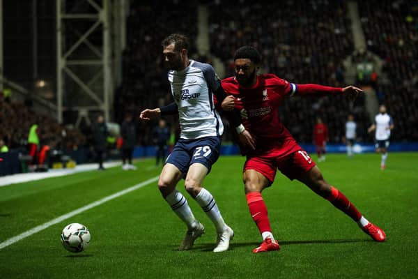 Preston North End winger Tom Barkhuizen vies for possession with Liverpool's Joe Gomez in the Carabao Cup at Deepdale