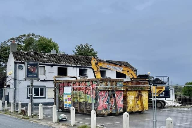 Excavators arrive at the Saddle Inn in Lea to prepare for demolition.