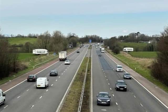 The M6 with the lorries in a field on each side before the removal of the adverts. Picture from Lancaster City Council.
