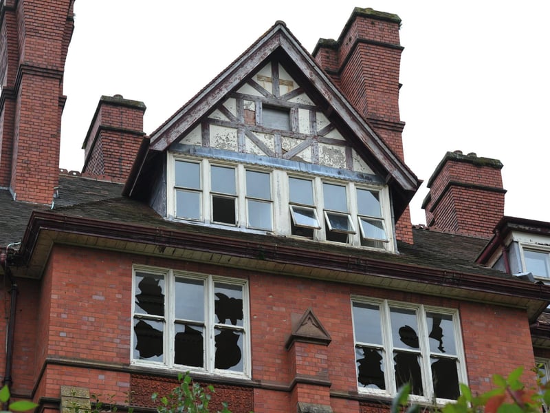 The upper floors of the building are completely exposed through smashed windows.