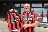 Morecambe fan Anthony Sparks with a new shirt for himself and his five-year-old grandson.