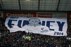 A giant banner is passed around by the Preston North End fans to remember club legend Sir Tom Finney