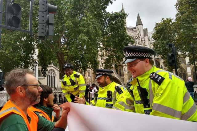 The group established roadblocks on all four corners of Parliament Square, with some gluing themselves to the road surface (Credit: Just Stop Oil)