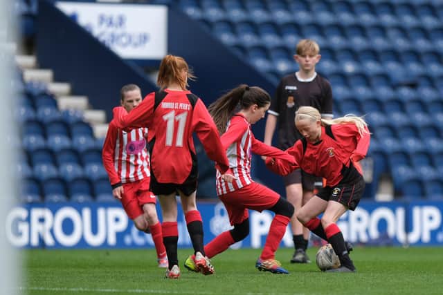 Brockholes Wood Primary School (red and white stripes) battle it out with St Peter's CofE Primary in the Dick, Kerr Ladies Shield final. Pic: John Shirras - @john_shirras