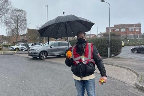 Volunteers go out of their way to help residents get their jabs safely come rain or shine. Gio DiCabria is pictured out on the job in a downpour.