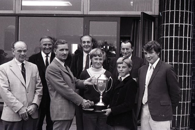 The Penwortham Golf Club's Open Boys Challenge Trophy attracted 46 entries from 16 clubs throughout Lancashire. Picture shows Penwortham captain Mr B Crabtree presenting the challenge trophy to D Collinson. In the centre is MS Brennand, runner-up and right M Tyrer of Preston, best gross