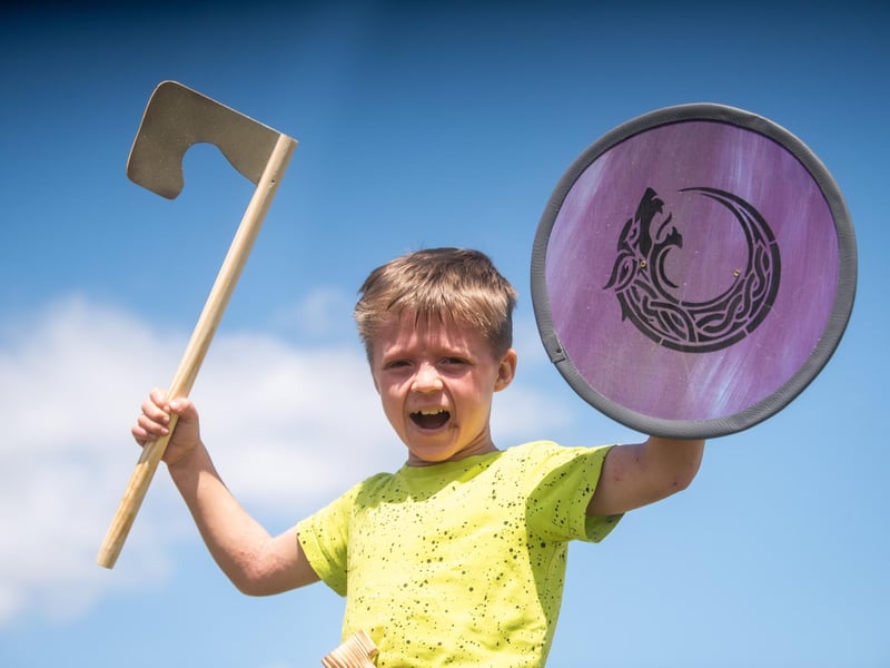 Heysham Viking Festival 2026 - a child with a toy shield and axe at the festival.