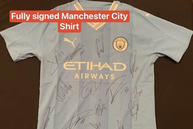 All the Manchester City squad have signed this shirt, which is up for grabs.