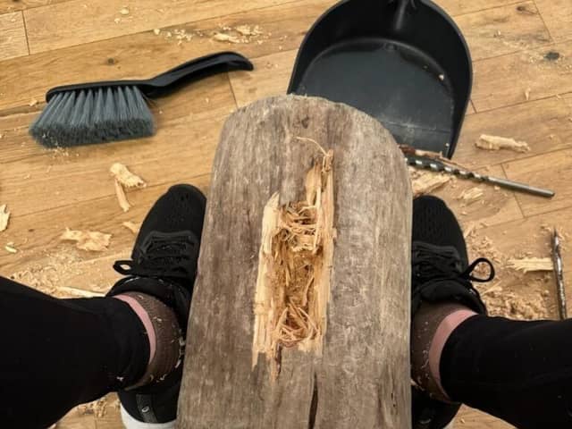 Vicki Lowe at work carving the tree stump found in the sea near her home