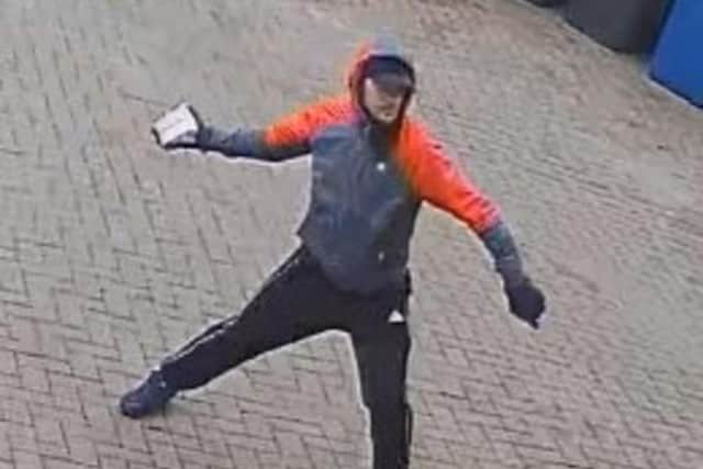 Detectives want to speak to this man after two cars were deliberately set on fire in Blackburn (Credit: Lancashire Police)