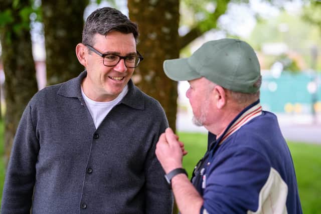 Andy Burnham chats to a member of the public during a visit to Platt Bridge