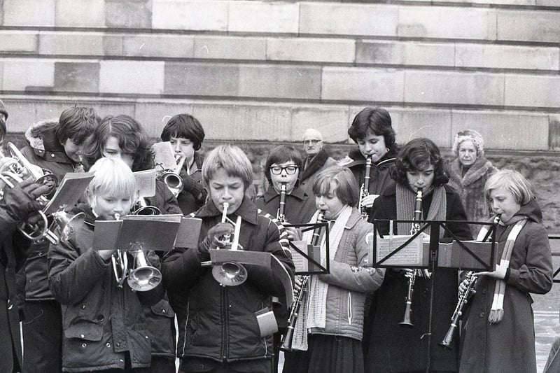 Providing a Christmas treat for the passing throngs of shoppers requires a great deal of concentration, as well as huff and puff - as this pictures shows during Tulketh High School Band's carol outing to Preston Flag Market