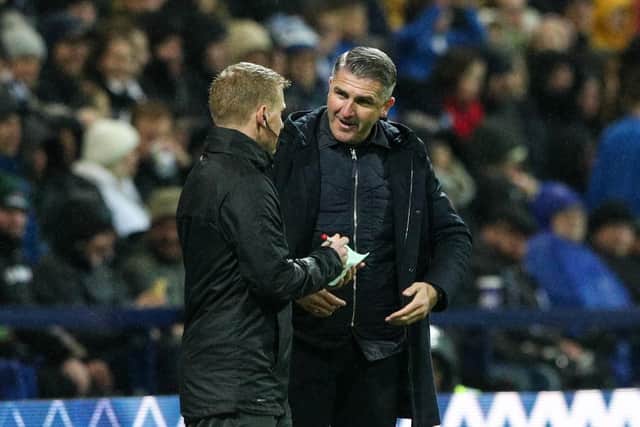 Preston North End manager Ryan Lowe has a word with fourth official John Busby during the win against Blackpool at Deepdale