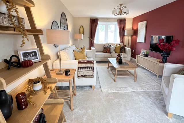 The show home lounge at Tower Gardens is styled in rustic red with ochre tones. Photo: Stanza Style